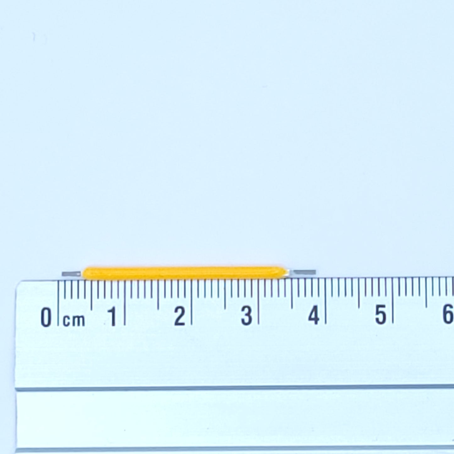 Ruler with a yellow LED on a light blue background