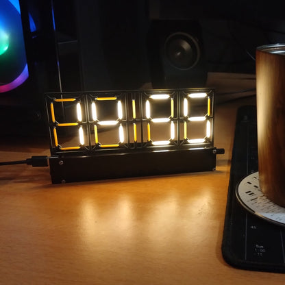 Desk setup with a cup, digital clock, and RGB lighting