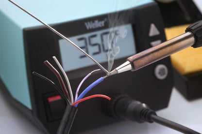 Soldering iron heating up wires with a digital display showing temperature.